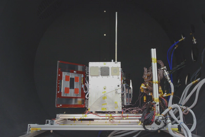 Deployable solar panel system TVAC test setup: T-slot test stand with a spacecraft bus mounted to it, supporting two panels